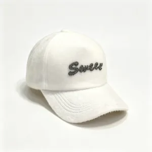 Close-up of white fuzzy baseball cap featuring sparkly Sweet rhinestone lettering