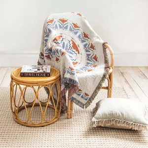 Native American inspired bohemian woven blanket with fringes on bamboo chair
