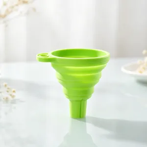 Detail view of a bright green collapsible silicone funnel for liquid dispensing.