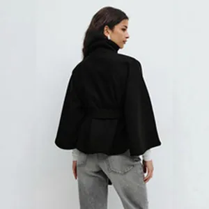 Back view of an elegant black wool-like cape coat with a stand collar and belted waist