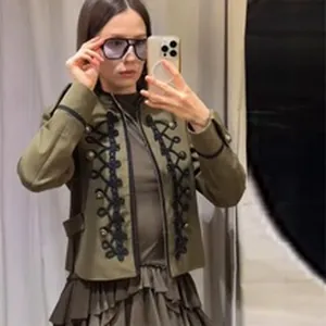 Military-style green jacket with black braided frogging details and stand collar