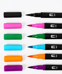 Detailed macro view showing multi-colored brush nibs and matching protective pen caps