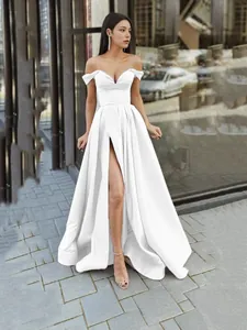 Elegant white off-the-shoulder V-neck evening gown with high slit and backless style