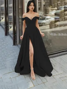 Elegant off-shoulder black evening gown with V-neckline and high leg slit detail