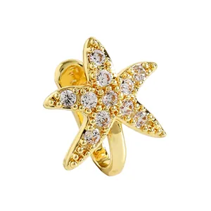 Detailed macro view of a gold starfish non-pierced nose clip inlaid with sparkling cubic zirconia