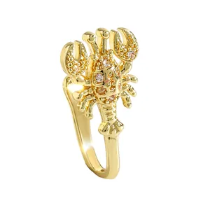 Detailed view of a gold lobster-shaped non-pierced nose clip with sparkling cubic zirconia