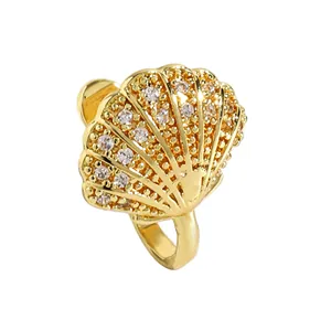Detailed view of gold shell-shaped non-pierced nose clip with cubic zirconia inlay.