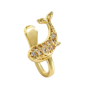Detailed view of a gold-tone whale-shaped nose clip set with sparkling zircons