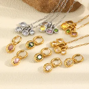 Detail shot of hammered gold earrings and necklaces with colorful cubic zirconia stones.