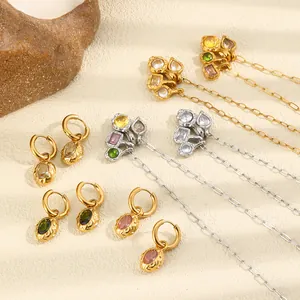 Detailed view of hammered gold jewelry sets with colorful zircons and refined textures.