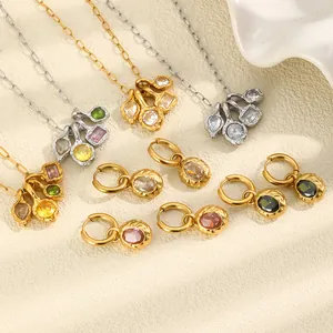 Close-up of French style stainless steel jewelry set with colorful zirconia and hammered texture