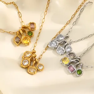 Detailed shot of gold and silver hammered necklaces with vibrant multicolor zircon pendants.