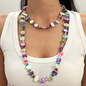 Detailed view of vintage Maillard style colorful beaded layered necklace worn on model