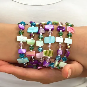 Detail of vintage Maillard style beaded layered necklace with colorful shell pieces.