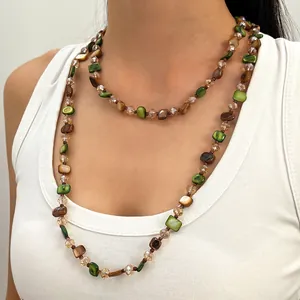 Detail of vintage Maillard style layered beaded necklace with brown and green shell beads
