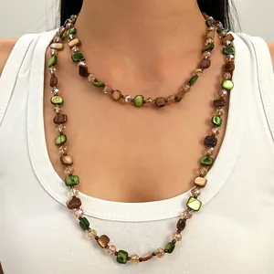 Close-up of retro Maillard style layered beaded necklace with green and brown beads