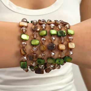 Macro view of layered beaded bracelets in retro Maillard style with green and brown beads