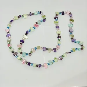 Detailed macro view of vintage multi-color beaded sweater necklace with shell pieces