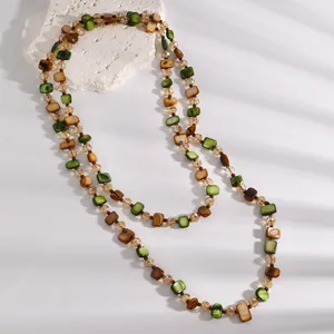 Close-up of retro Maillard style beaded layered necklace with green and brown beads