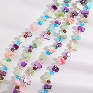 Macro view of a retro layered beaded necklace featuring colorful shell pieces and crystals.