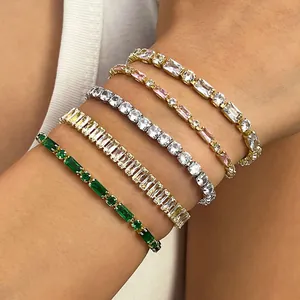 Elegant stack of sparkling tennis bracelets in gold and silver with colorful crystals