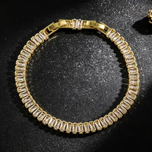 Macro view of gold tennis bracelet with sparkling baguette-cut cubic zirconia stones
