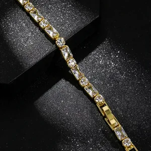 Close-up macro detail of an elegant gold-toned bracelet with clear rectangular stones