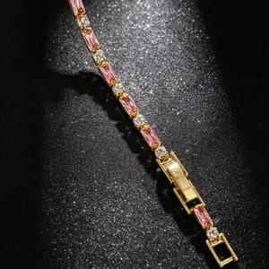 Detail view of a gold bracelet with rectangular pink stones and clear crystal accents.