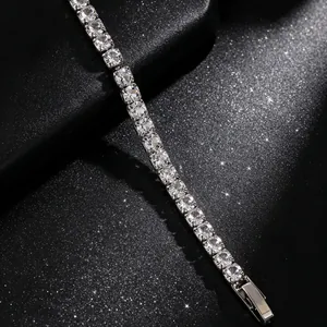 Detailed macro shot of a sparkling crystal tennis bracelet on a black glittery background.