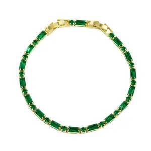 Elegant gold plated bracelet with rectangular emerald green baguette cut gemstones