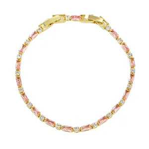 Close-up of elegant gold-tone bracelet featuring pink baguette stones and clear accents