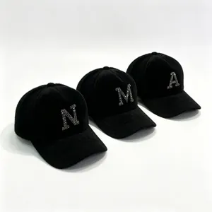 Three black mink fur baseball caps featuring rhinestone initials N, M, and A design