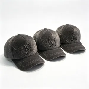 Detail of grey mink hair baseball caps with rhinestone letters N, M, and A.