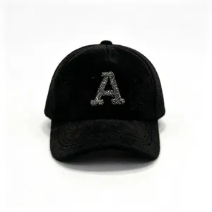 Close-up of a black mink fur baseball cap with sparkling rhinestone letter A decoration