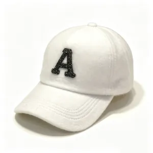 Close-up of luxury white faux mink fur baseball cap with black rhinestone letter A