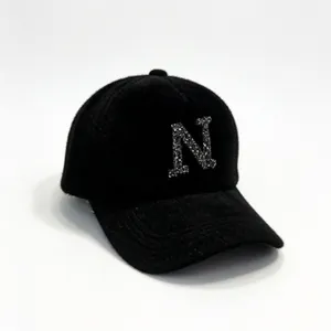 Close-up of black fuzzy mink-like baseball cap with rhinestone letter N decoration