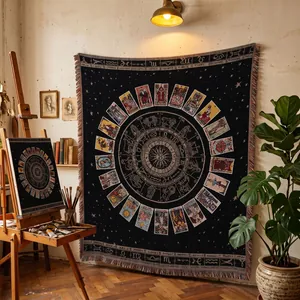 Large black tarot card tapestry blanket with intricate zodiac wheel design in art studio setup