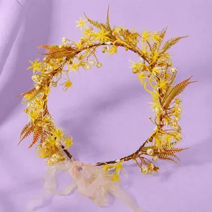 Elegant yellow artificial flower wreath crown with soft pink ribbon for weddings and parties