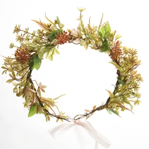 Elegant bohemian floral wreath headband with realistic artificial flowers and pink ribbon
