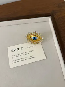 Close-up detail of vintage evil eye ring featuring blue iris and sparkling rhinestones.