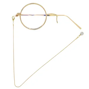 Retro gold stainless steel monocle with chain and cat eye stone bead on white background