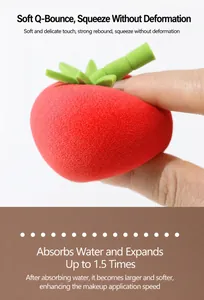Macro shot of a strawberry shaped makeup sponge being squeezed to show its soft texture.