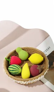 Close-up of colorful fruit-themed makeup sponges in a basket for product details