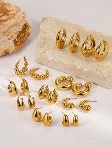 Assorted collection of gold plated stainless steel hoop and stud earrings with glossy finish