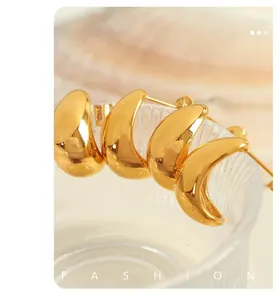 Close-up detail of four gold-plated stainless steel crescent stud earrings