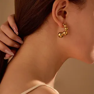 Gold-plated stainless steel C-shaped hoop earrings with irregular bead design