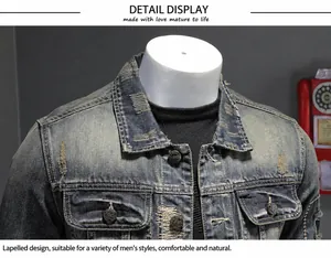 Detailed macro view of vintage distressed denim jacket with ripped patches and metal buttons