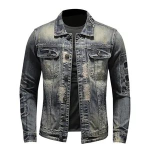 Vintage men's distressed denim jacket with heavy repair patches and washed finish.