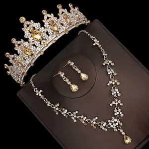 Close-up view of a luxury champagne crystal bridal crown necklace and earring jewelry set