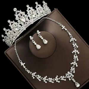 Detail view of luxury bridal jewelry set with sparkling tiara, necklace and teardrop earrings